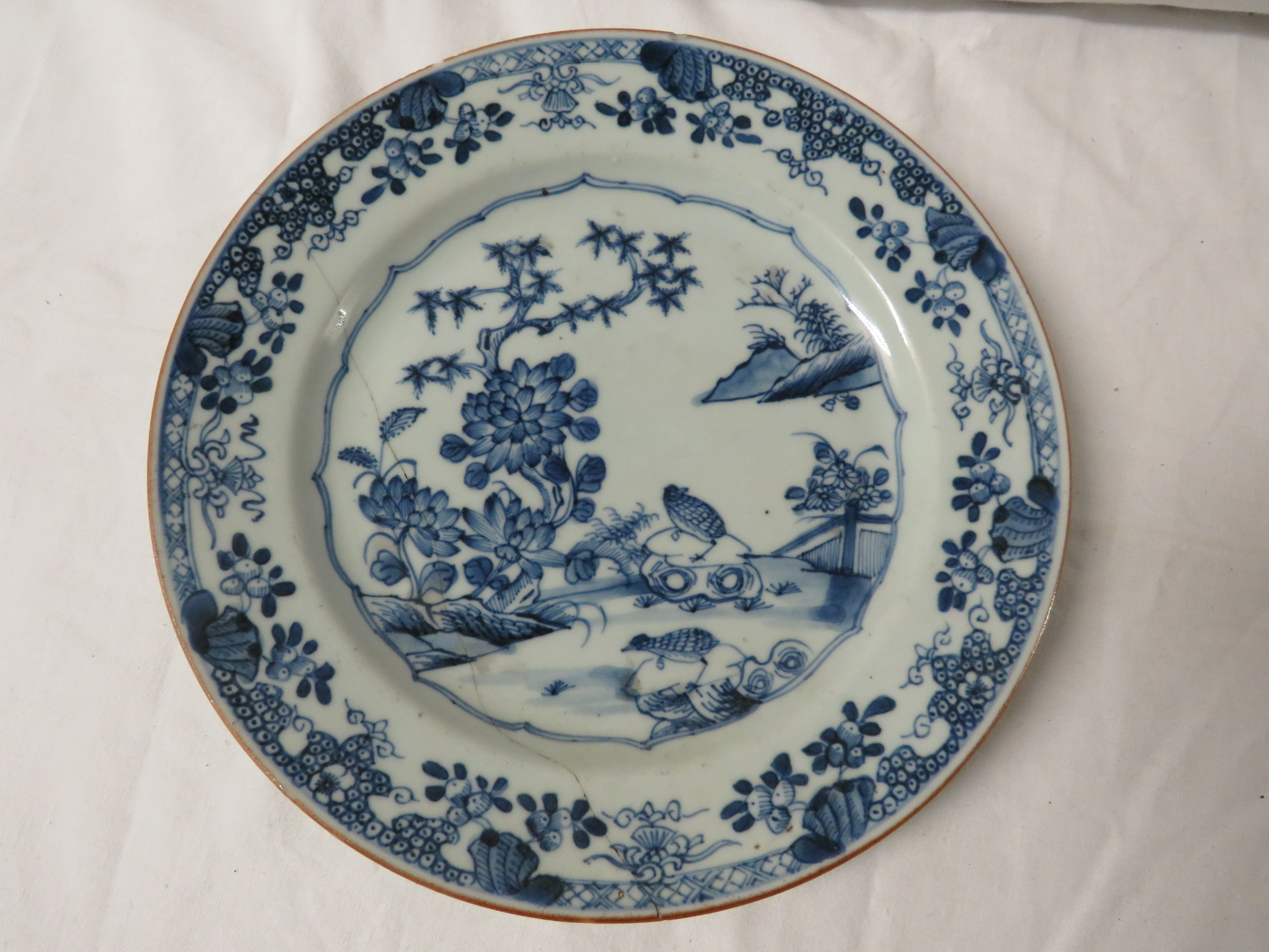 An octagonal Chinese blue and white porcelain plate painted with houses in landscape and a patterned - Image 2 of 5