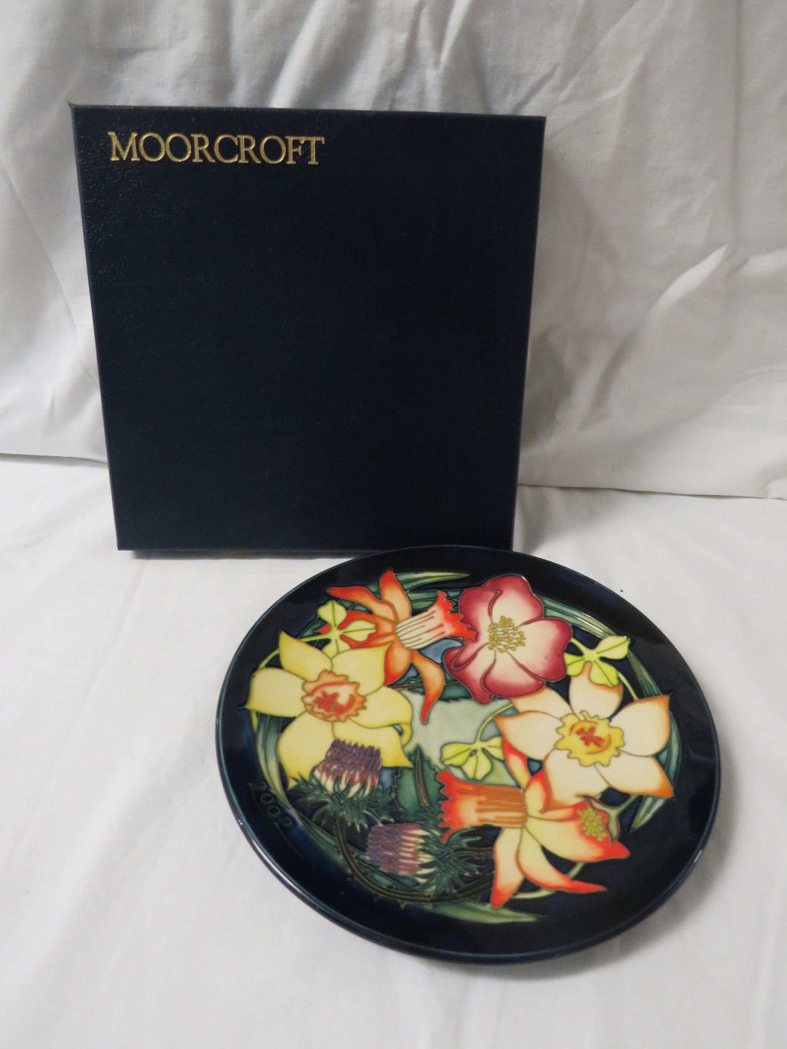 Moorcroft pottery QEII Golden Jubilee plate, dark blue ground, tube lined decoration of variously - Image 2 of 4