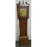 A 19th century thirty hour long case clock with polished brass dial and spandrels and Roman