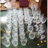 LARGE SELECTION OF CUT GLASS DRINKING VESSELS INCLUDING CHAMPAGNE FLUTES, BRANDY GLASSES AND