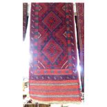 RED GROUND HAND KNOTTED WOOLLEN FLOOR RUNNER WITH FIVE MEDALLIONS (275CM X 60CM)