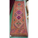 HAND KNOTTED WOOLEN MESHWANI RECTANGULAR FLOOR RUNNER, RED AND BLUE GROUND WITH SIX MEDALLIONS (