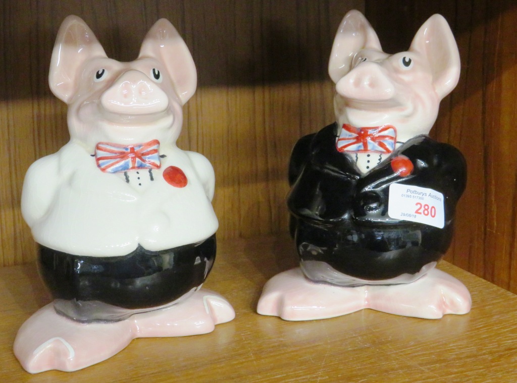 TWO WADE NATWEST PIGGY BANKS WEARING UNION JACK BOW TIES, BOTH WITH STOPPERS