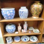 THREE SHELVES OF ORIENTAL STYLE CERAMICS INCLUDING LIDDED JARS AND PLANTERS