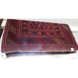 RED GROUND HAND KNOTTED WOOLLEN FLOOR RUG WITH TASSELLED ENDS (125CM X 120CM)