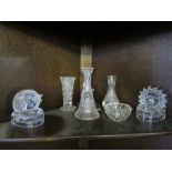 THREE SHELVES OF CUT GLASS ITEMS INCLUDING DECANTER STOPPERS AND VASES