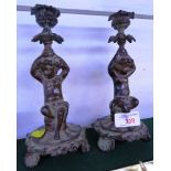 PAIR OF BRONZE VERDIGRIS FIGURAL CANDLESTICKS MODELLED AS CHERUBS HOLDING URN SHAPED SCONCES, HEIGHT