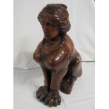 A carved mahogany model of a female sphinx seated on its hind legs, the head drilled perhaps for a