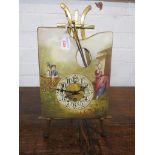 Brass and enamelled porcelain table clock as an artist's palette on easel, the dial painted with a