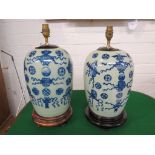 A pair of Chinese porcelain celadon glaze table lamps, ovoid, each decorated to one half in