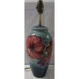 Moorcroft pottery blue ground table lamp decorated with red poppies and a cream shade, height 38cm