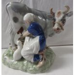 Royal Copenhagen porcelain group of woman milking cow, signed Axel Locher, numbered 443, 20cm