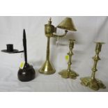 An iron rush light on a turned fruitwood base (height 24.5cm), a brass oil lamp with reservoir at