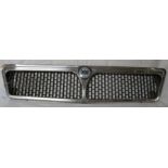 A Lancia grille with plastic badge, chromium plated metal and plastic, width 76cm, height 17cm