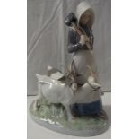 Royal Copenhagen porcelain group of girl with mallet and two billy goats, numbered 069, 23cm