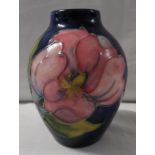 Moorcroft pottery ovoid vase, blue ground with pink anemone, height 9cm, stamped MOORCROFT MADE IN