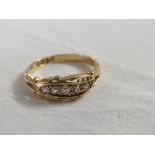 18 carat gold ring set with a row of five small graduated diamonds in a leaf-shape setting (the