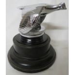 Chromium mascot and radiator cap for Ford Model A circa 1930, mounted on a stained black socle