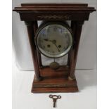 Oak chiming mantel clock, barrel case raised between the top of four Doric columns, gilt brass