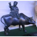 BRONZED CAST METAL FIGURE OF CHINESE BOY SEATED ON COW