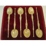 A cased set of six silver gilt teaspoons modelled as anointing spoons, marks for London, 1902,