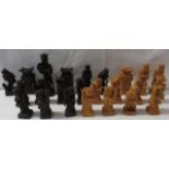 A part set of Chinese style carved light and dark wood figural chess pieces (eleven light and