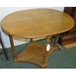 A French oak oval centre table supported on four fluted column legs to a lozenge shape platform