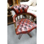 20th Century captains arm chair in oxblood leather on swivel