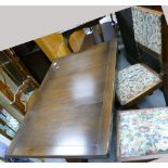 A twentieth century oak extending refectory dining table and two oak ladder back chairs and