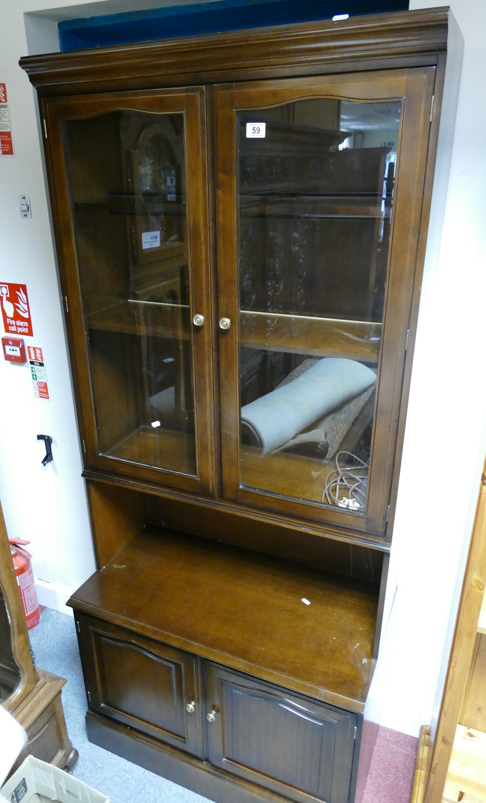 A stag slim display cabinet with two glazed doors above two door base