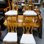 A quality reproduction light walnut and oak inlaid cross banded extending two leaf dining table on