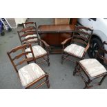 Twentieth century oak drop leaf dining table with five ladder back chairs including two carvers (6)