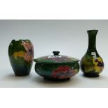 A collection of Moorcroft in the Hibiscus design to include round box and cover and two vases (3)