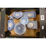 A collection of Wedgwood items to include tri-colour sweet box, mantle clock, pin trays,