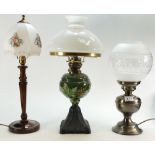Early 20th century embossed pottery oil lamp with glass shade and two other lamps with glass shades