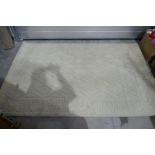A cream wool rug measuring 243 x 152cm