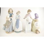 A collection of Nao figures to include girl with candle, girl with rabbit,