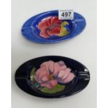 Moorcroft Clematis and hibiscus ash trays both on blue/brown (2)