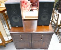 A mahogany record player unit with a 3-part Sanyo stereo system and record player,