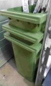 Three green Wheelie bins.