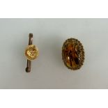 Yellow metal brooch set with amber and bar brooch with yellow metal ornate brooch later attached,