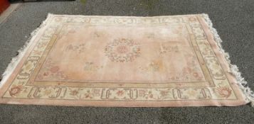 A Chinese rug in pink and cream