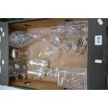 A collection of cut glass decanters, brandy glasses,