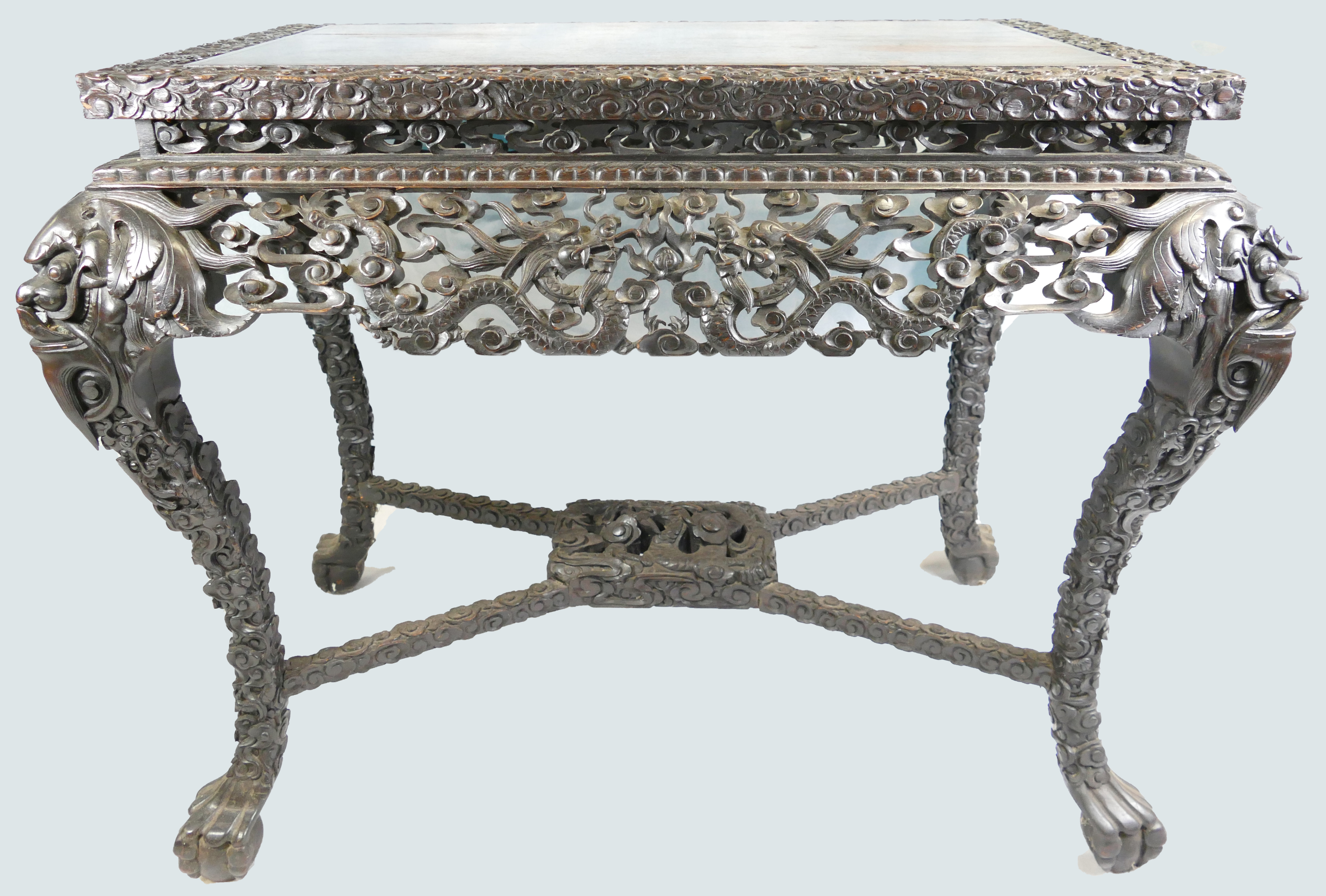 A 19th century Chinese dark wood centre table, the elaborate frieze and stretcher,