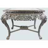 A 19th century Chinese dark wood centre table, the elaborate frieze and stretcher,