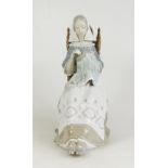Lladro large figure of a seated woman sewing, height 29cm, boxed.