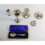 A collection of filled silver items including vases, inkwell, candlestick,