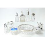 A collection of silver topped glass items including perfume bottles, fruit bowl, jar & covers,