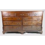 Early 19th century mahogany nine drawer dresser base, the top three dummy drawers with lift up top,