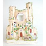 19th century Staffordshire model of a castle moulded with a pocket watch holder, height 29cm,